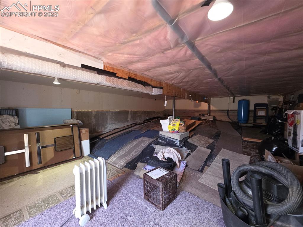 Image 34 of 50: this is underneath the great room, has the water pump and main shut off. Ex