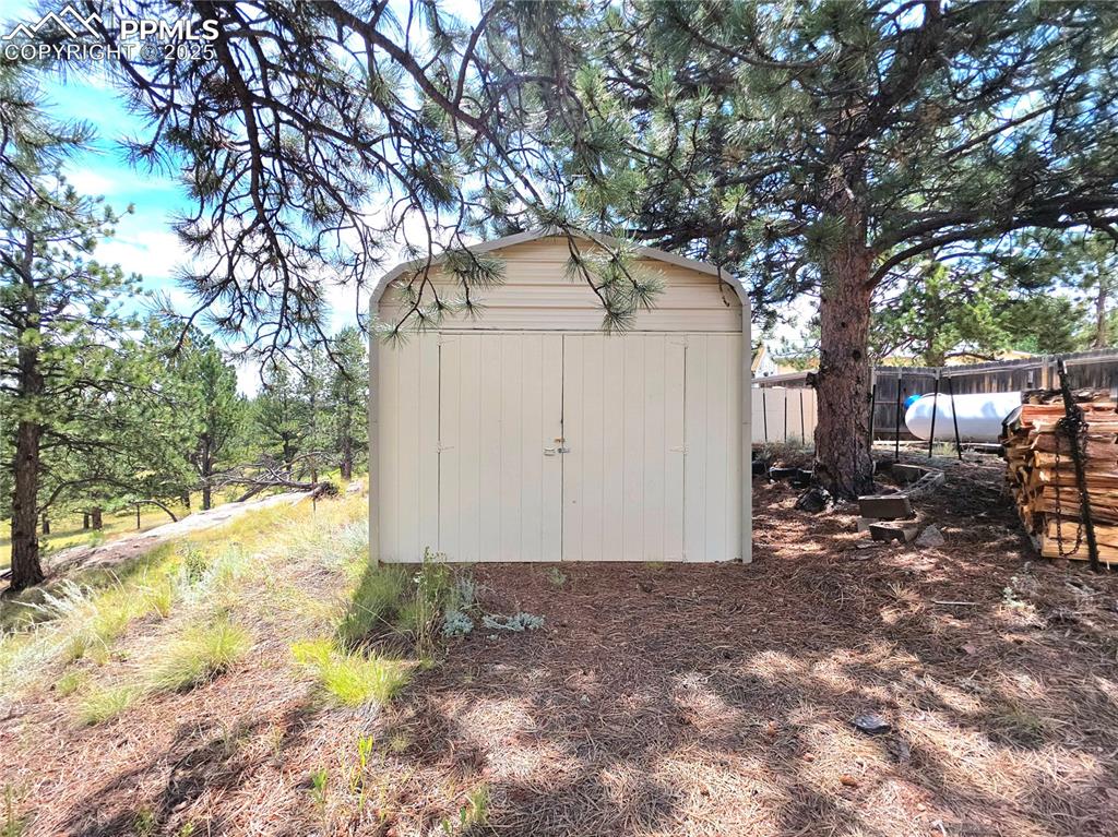 Image 38 of 50: This building opens on both ends and could be another garage, a great 1 or 
