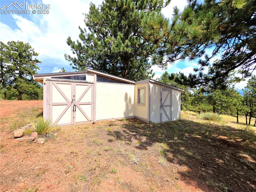 Image 40 of 50: Kindling and separate storage shed on the right