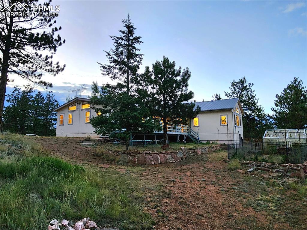 Image 44 of 50: Side and back of home, front of home looks West and back looks East towards
