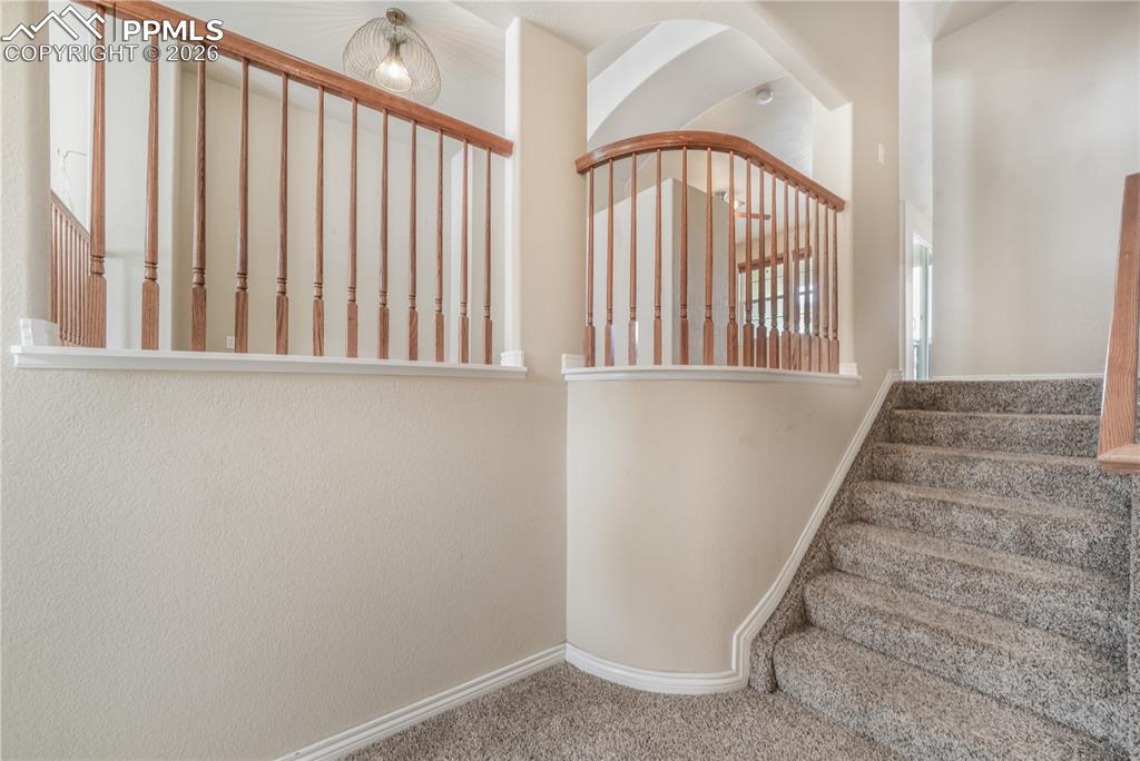 Image 10 of 50: Stairs to dining area, kitchen, family room