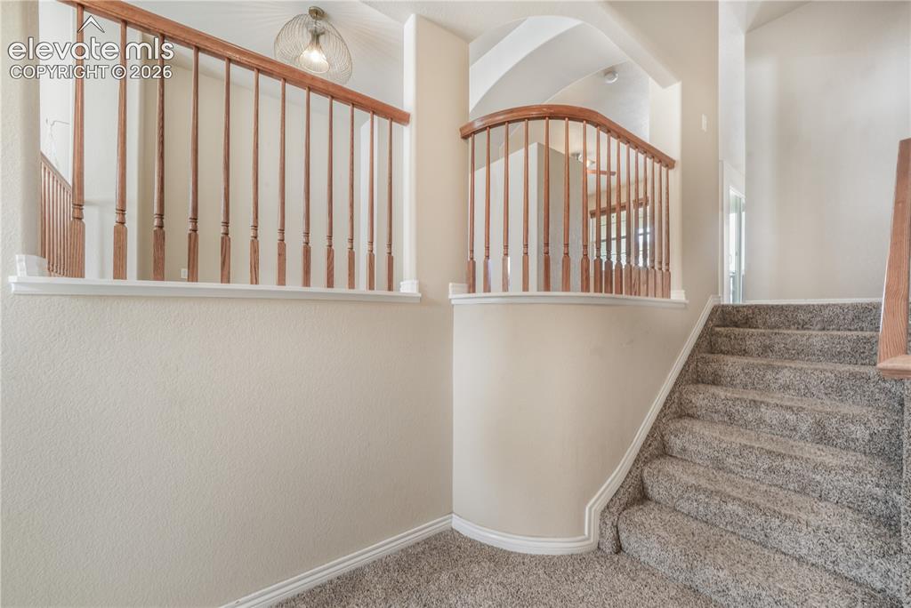 Image 11 of 50: Stairs to dining area, kitchen, family room