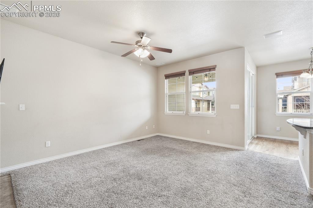 Image 14 of 50: Family room with gas fireplace, access to kitchen and walk out deck