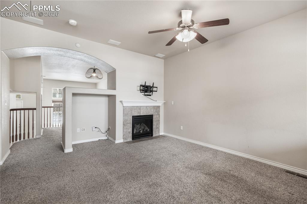 Image 15 of 50: Family room with gas fireplace, access to kitchen and walk out deck