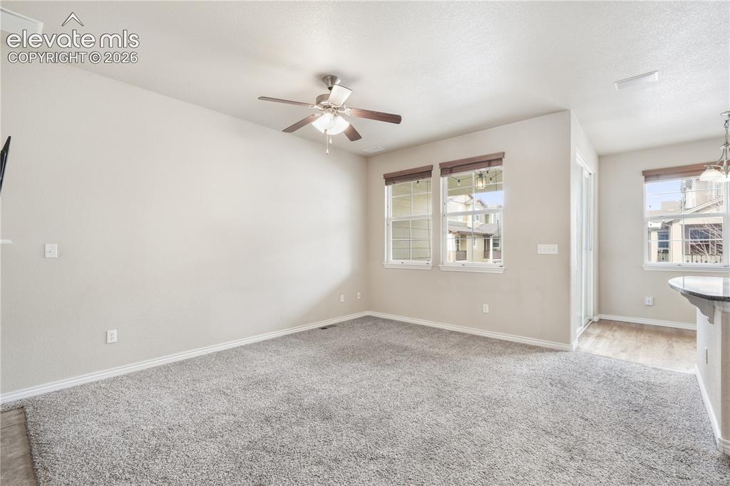 Image 15 of 50: Family room with gas fireplace, access to kitchen and walk out deck