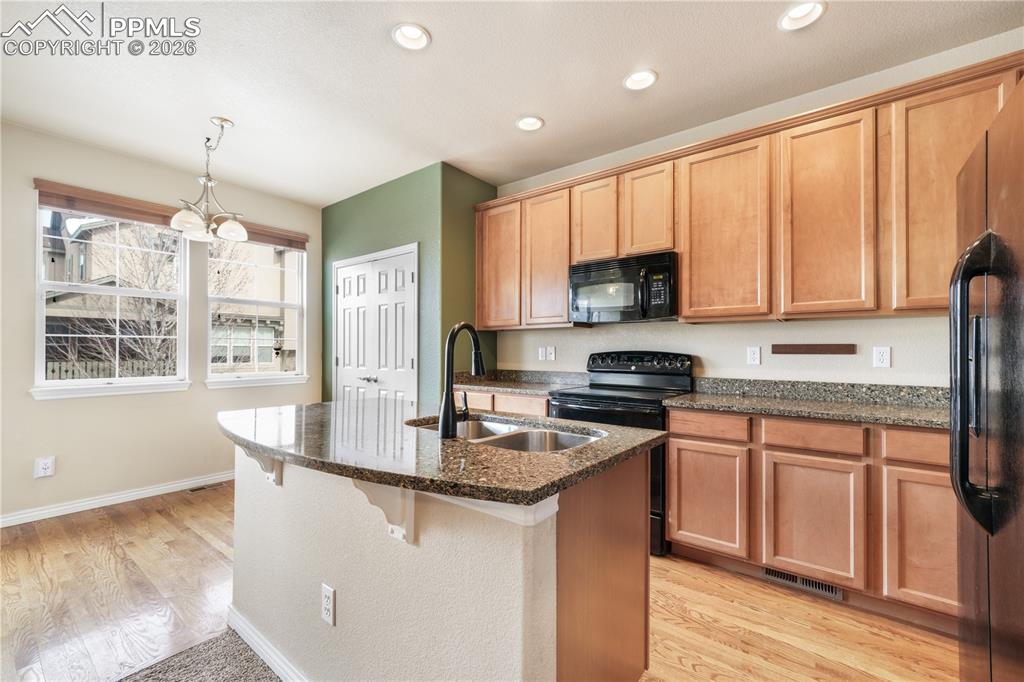 Image 19 of 50: Kitchen with granite countertops, large island, additional breakfast eat in