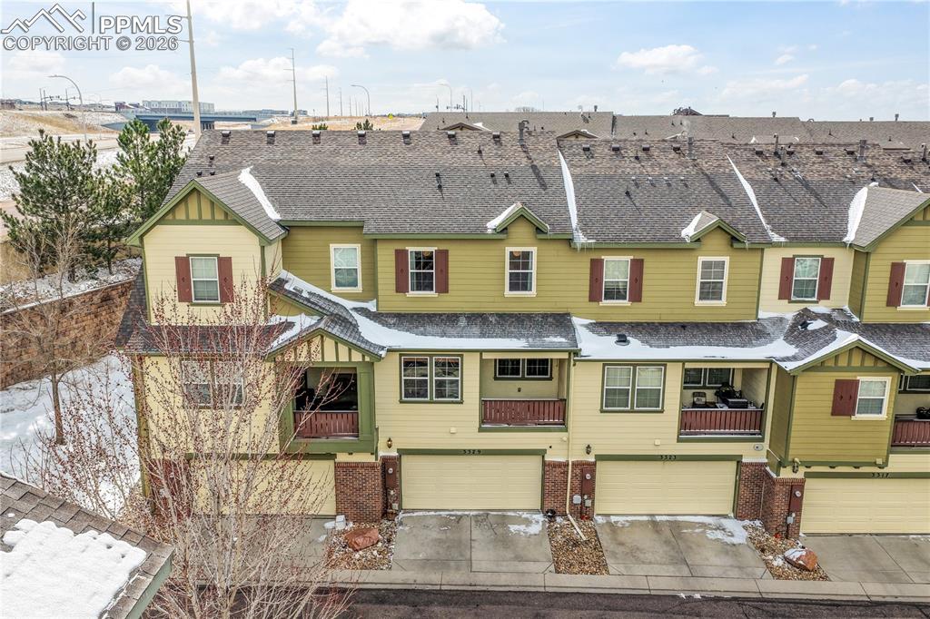 Image 2 of 50: Back of home showing 2 car garage and covered patio