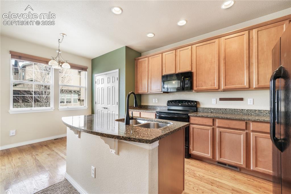 Image 20 of 50: Kitchen with granite countertops, large island, additional breakfast eat in