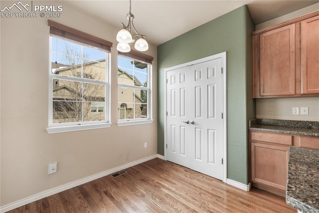 Image 21 of 50: Breakfast eat in area, pantry and covered patio access