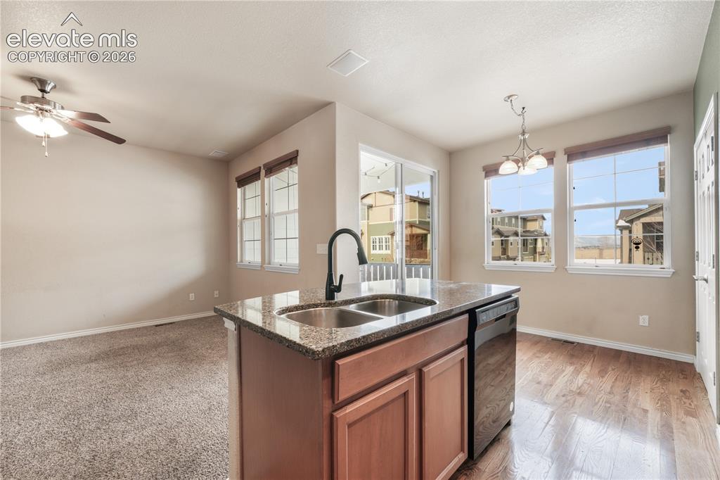 Image 21 of 50: Kitchen with granite countertops, large island, additional breakfast eat in