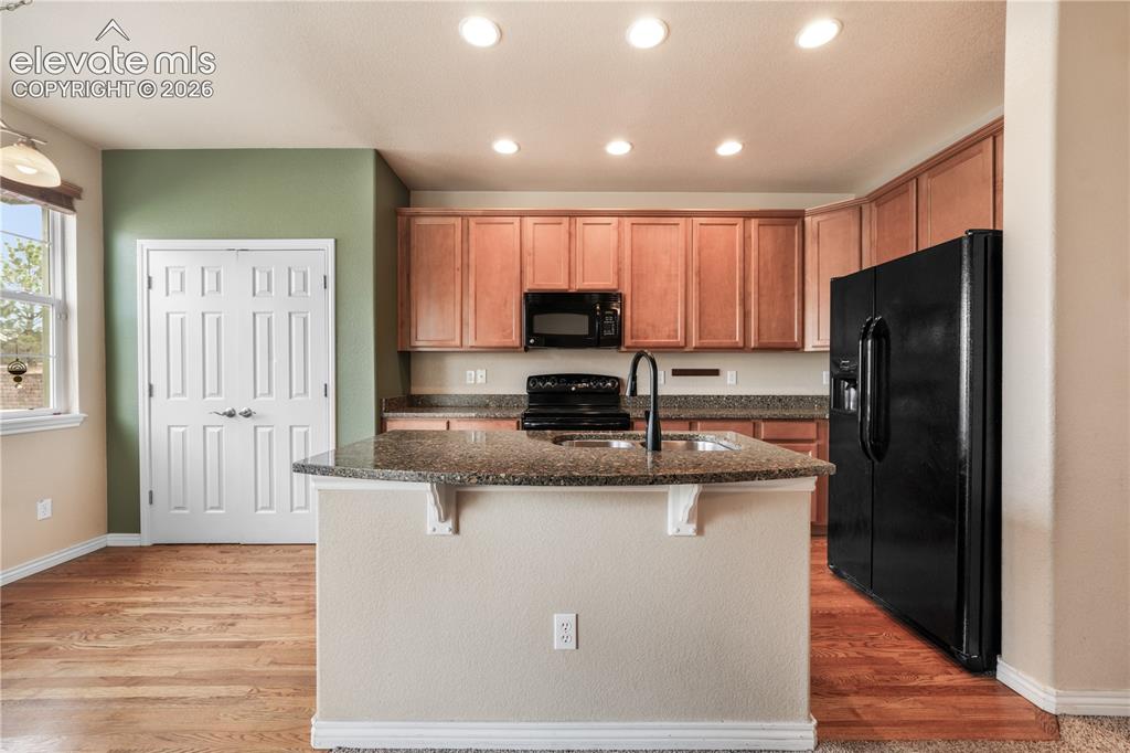 Image 26 of 50: Kitchen with granite countertops, large island, additional breakfast eat in