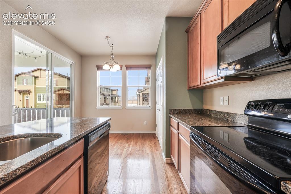 Image 27 of 50: Kitchen with granite countertops, large island, additional breakfast eat in