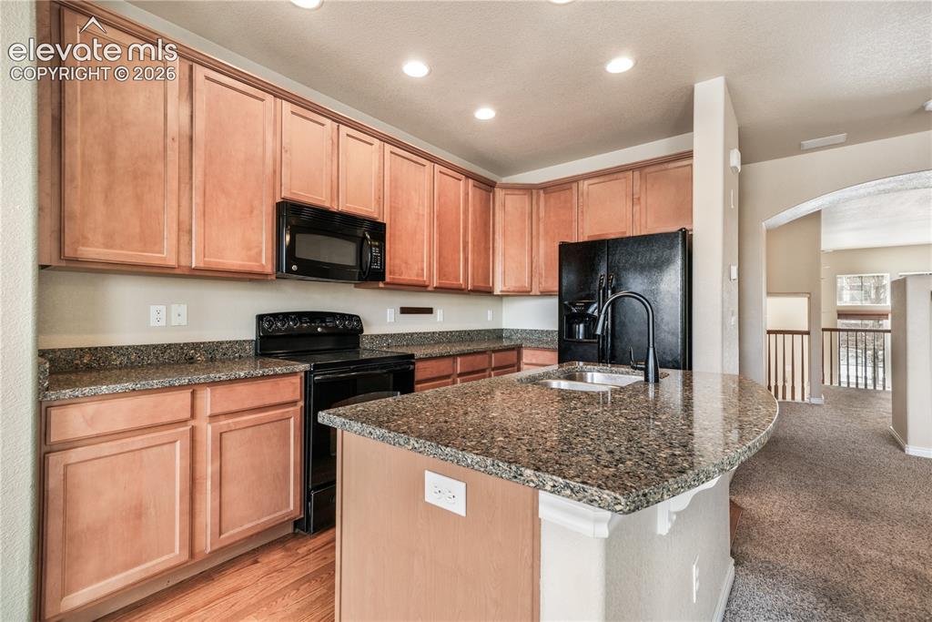 Image 28 of 50: Kitchen with granite countertops, large island, additional breakfast eat in