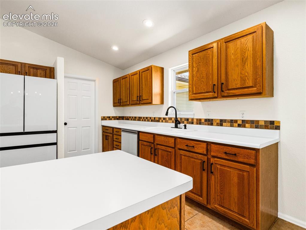 Image 11 of 50: Pantry is the door in the background
