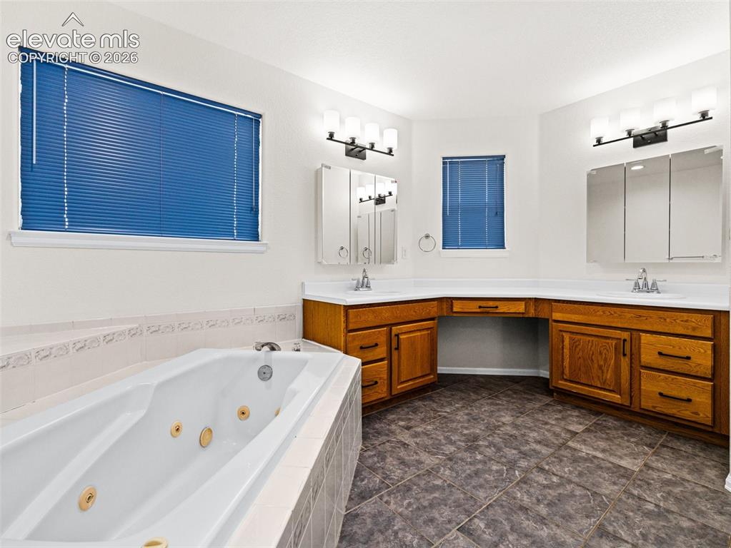 Image 18 of 50: Large bath with jetted tub, walk in shower, separate toilet, new fixtures,