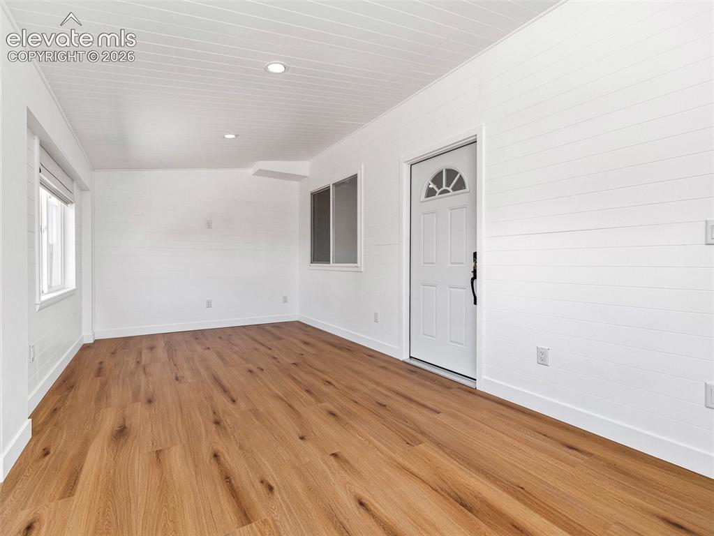 Image 27 of 50: The enclosed porch to the ADU offers additional living space, if desired