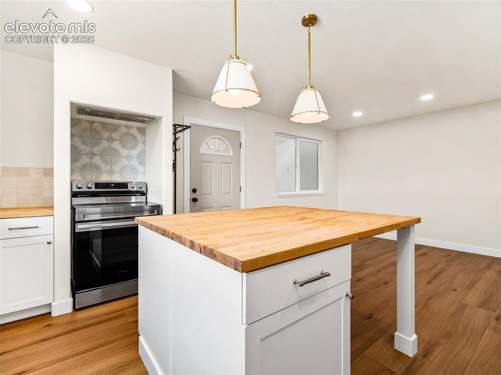 Image 29 of 50: This is the kitchen in the ADU with LVP, Butcher block counter tops, gold a