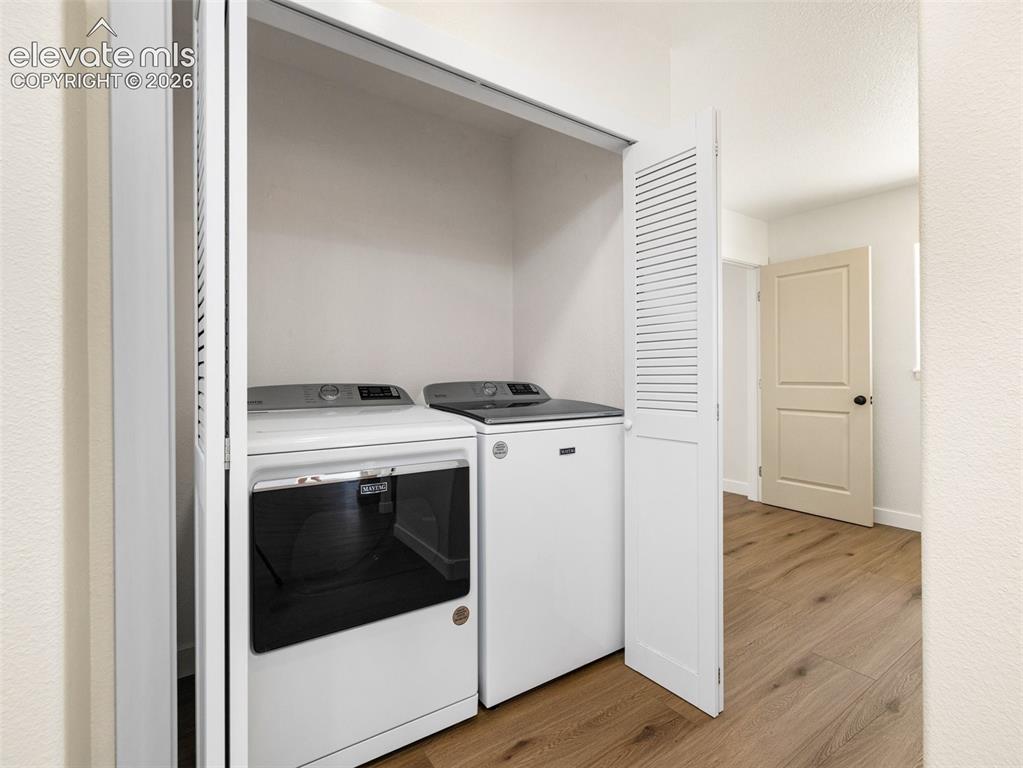 Image 38 of 50: This laundry space is off the living room in the ADU