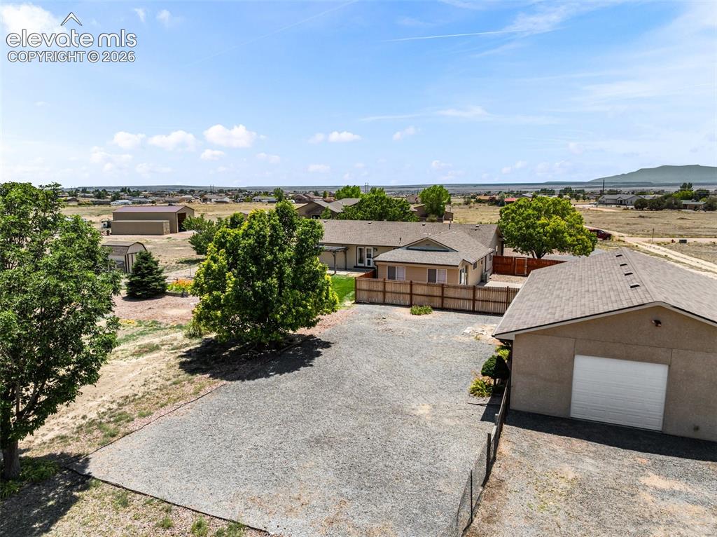 Image 5 of 50: Back view of 4.85 acres with a 1500 sq ft outbuilding on a concrete floor