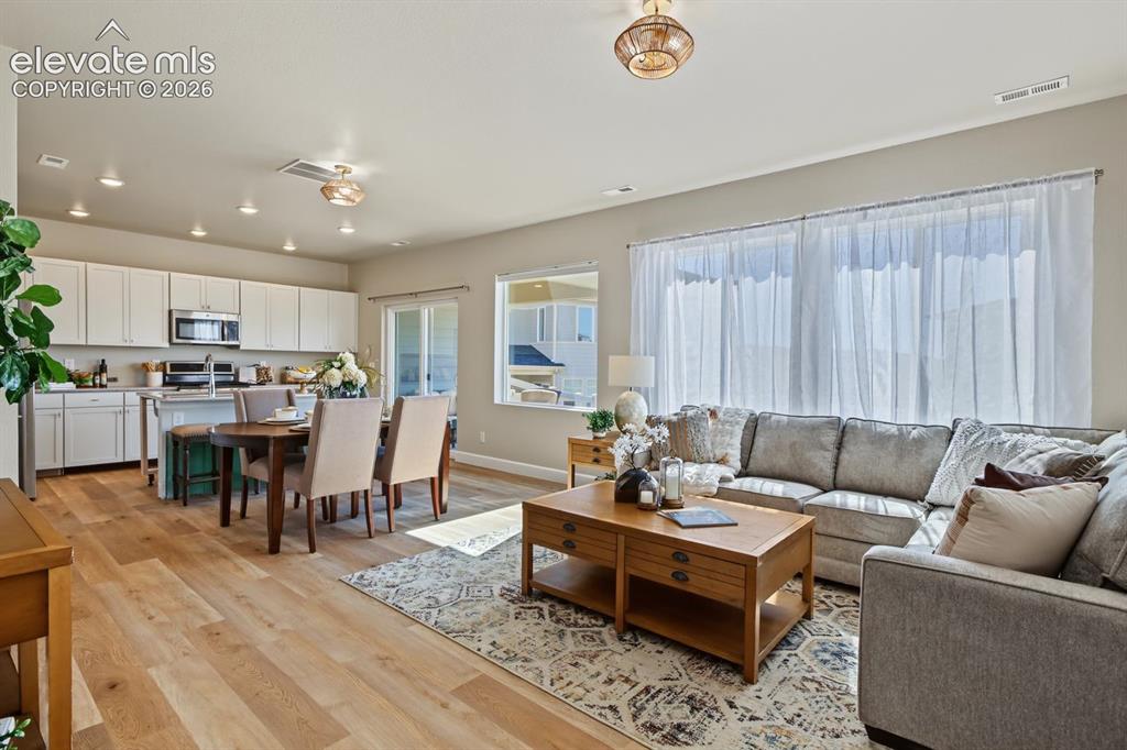 Image 2 of 34: Great Room with main level living area, dining rom and kitchen