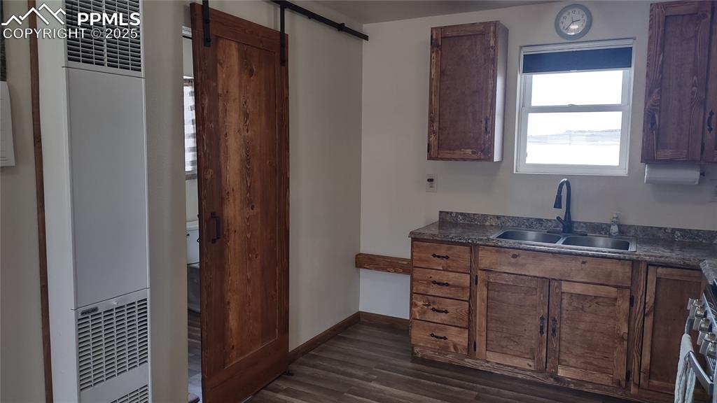 Image 16 of 38: Sliding barn door to bath.