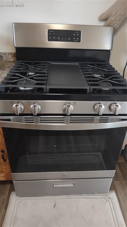 Image 17 of 38: Stainless gas range/oven.