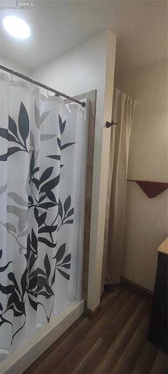 Image 21 of 38: Roomy shower has light above.