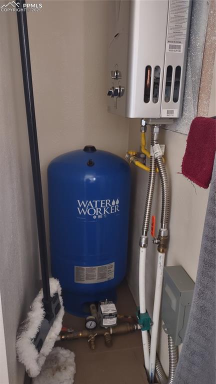 Image 23 of 38: Pressure tank and tankless on-demand water heater.