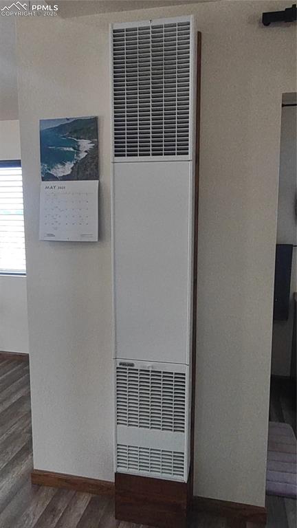 Image 24 of 38: Propane wall heater keeps cabin toasty.