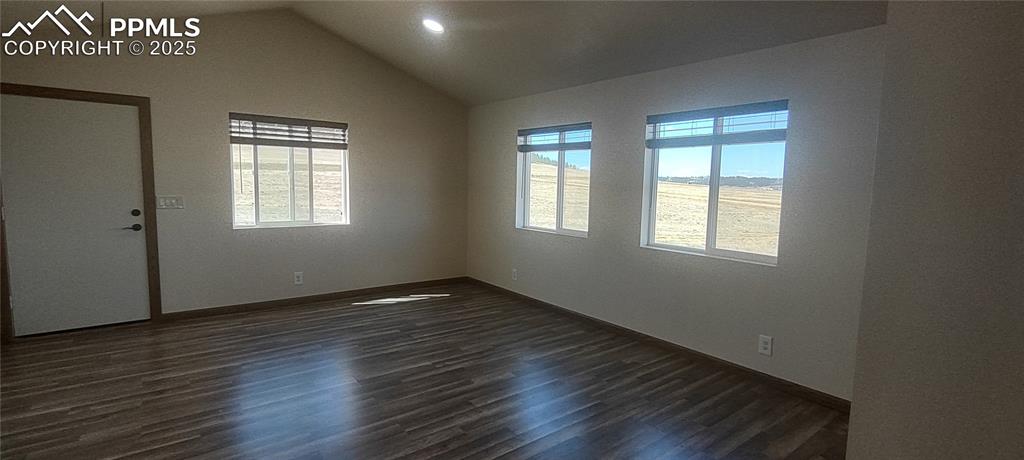 Image 8 of 38: Living/sleeping area with gorgeous laminate flooring.