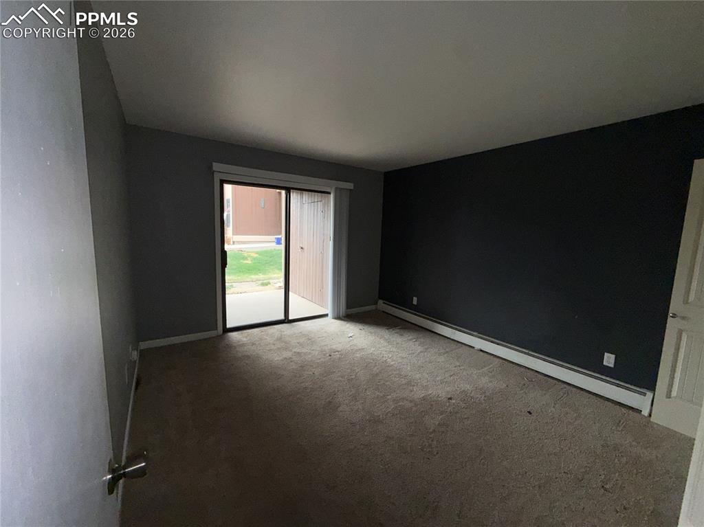 Image 7 of 9: Primary bedroom with walk out to patio