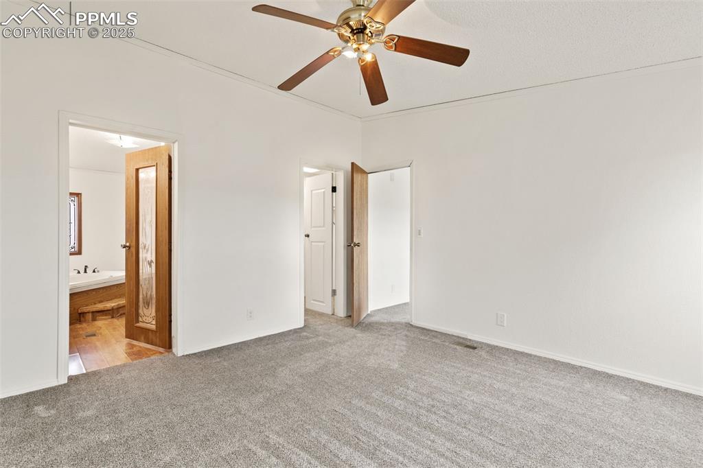 Image 24 of 50: Primary bedroom with attached bath and walk in closet