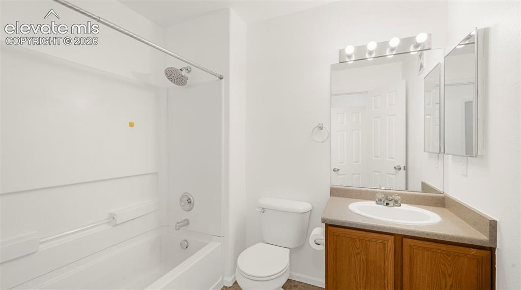 Image 25 of 30: Bathroom featuring a white tub/shower combination with a chrome showerhead,