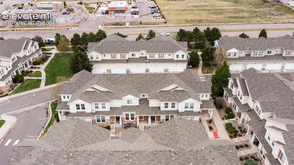 Image 3 of 30: Residential complex featuring multiple townhouse-style buildings with light