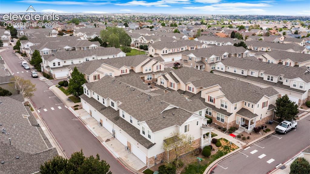 Image 5 of 30: Expansive residential community featuring numerous multi-story townhomes wi