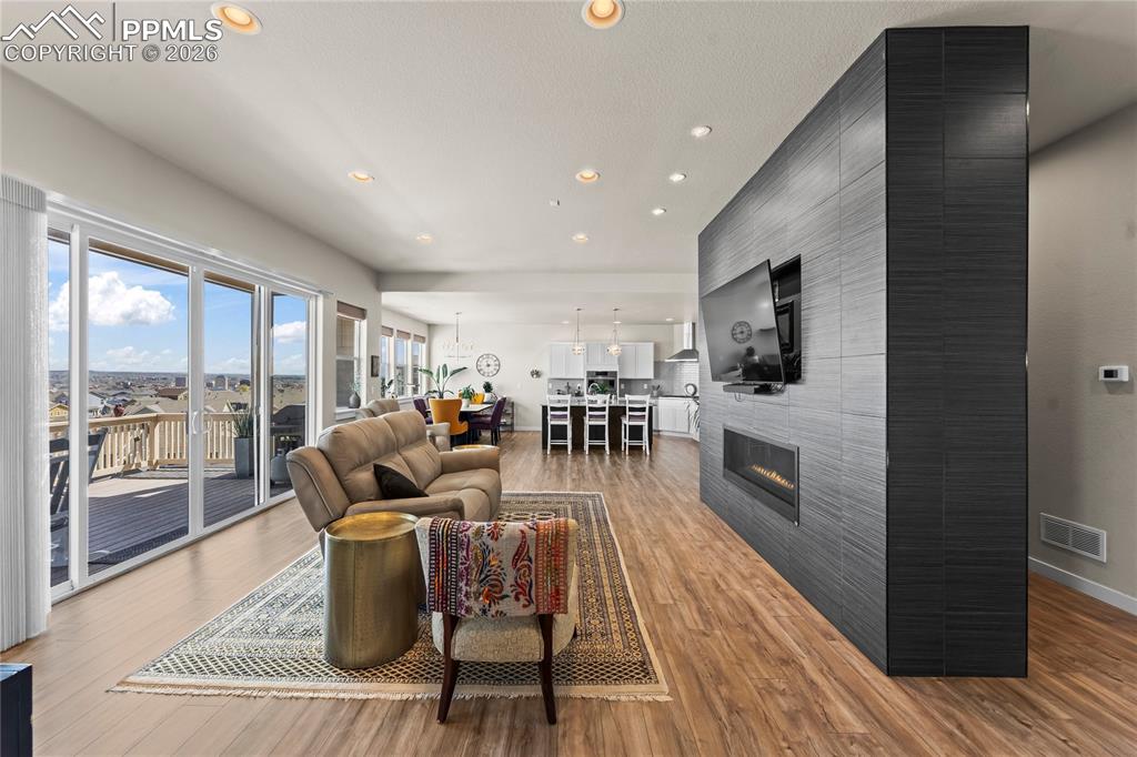 Image 13 of 50: Main level living space with gas fireplace