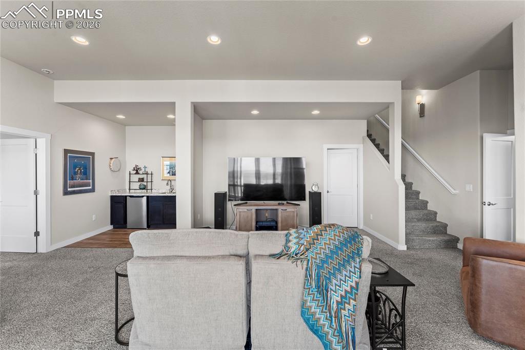 Image 31 of 50: Basement includes a wet bar