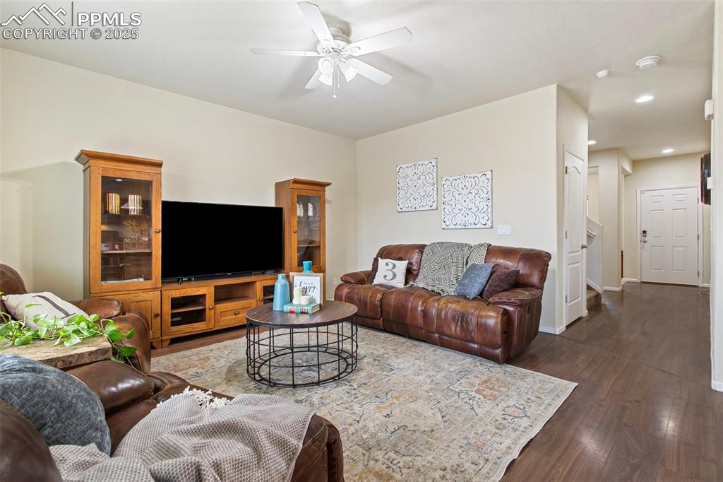 Image 7 of 26: Living room with recessed lighting, baseboards, ceiling fan, and dark wood-