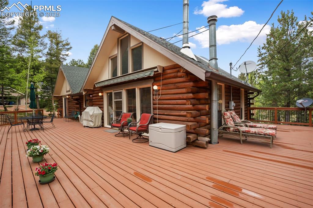 Image 4 of 36: Wooden deck featuring outdoor dining space