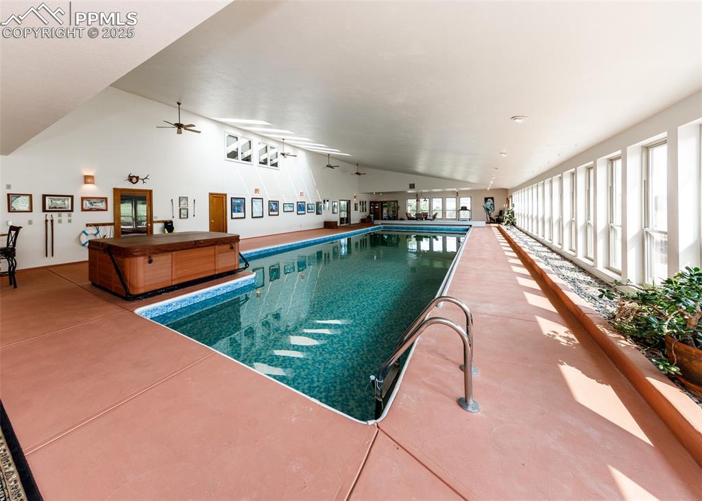 Image 19 of 41: Indoor pool with ceiling fan