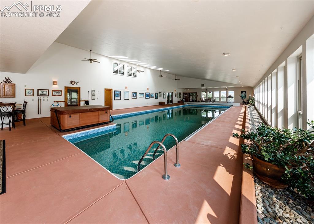 Image 24 of 41: Indoor pool featuring a ceiling fan