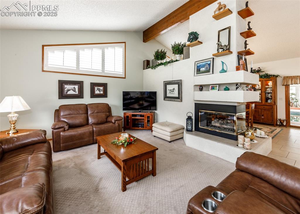 Image 40 of 41: Living room featuring plenty of natural light, a textured ceiling, a glass