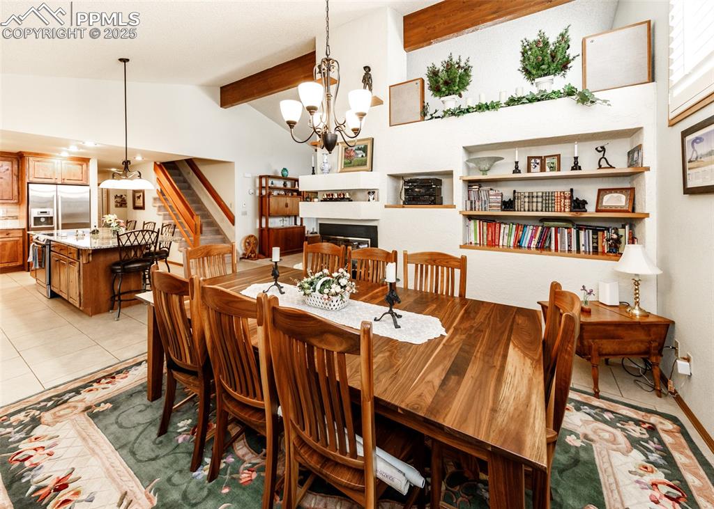 Image 5 of 41: Dining space featuring stairs, a chandelier, light tile patterned floors, a