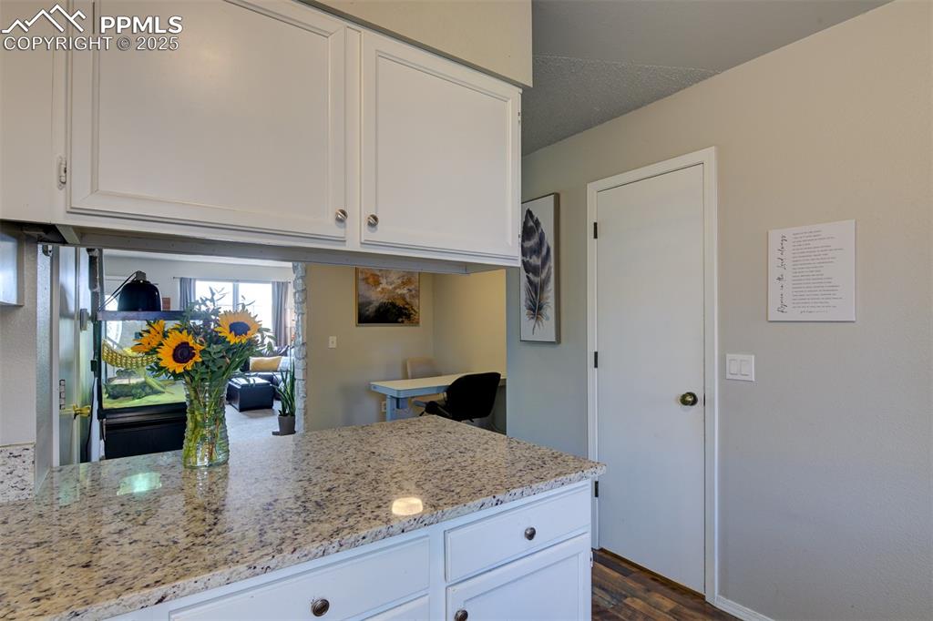 Image 12 of 34: Breakfast bar and prep area. 1/2 bath shown to the right.