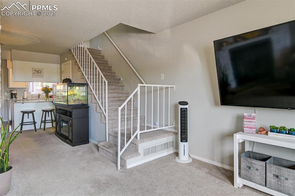 Image 15 of 34: Stairway up to Bedrooms and Full bathroom