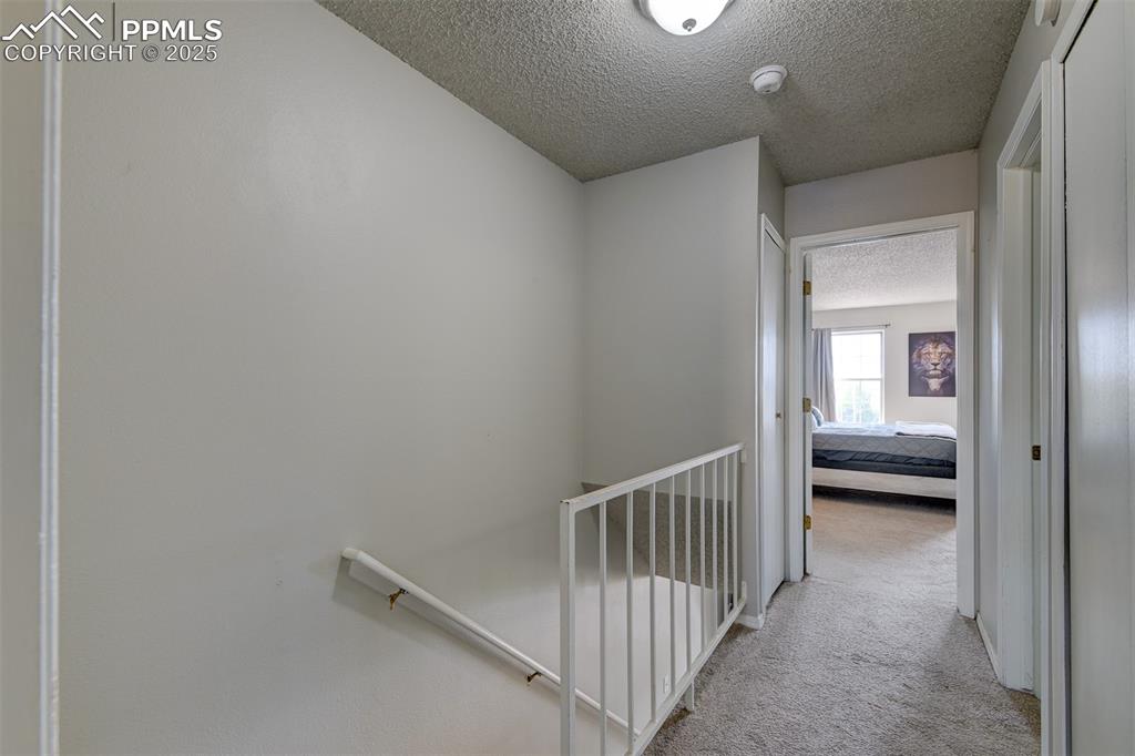 Image 24 of 34: Hallway between bedrooms