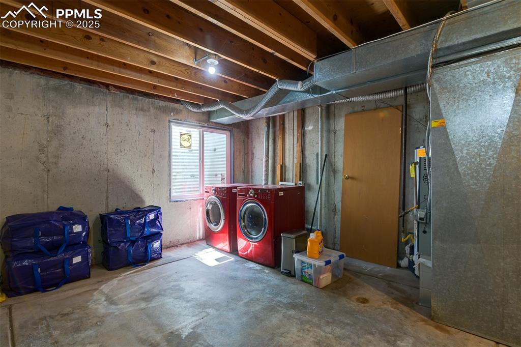 Image 27 of 34: Laundry area and unfinished basement. Perfect for storage or finish and add
