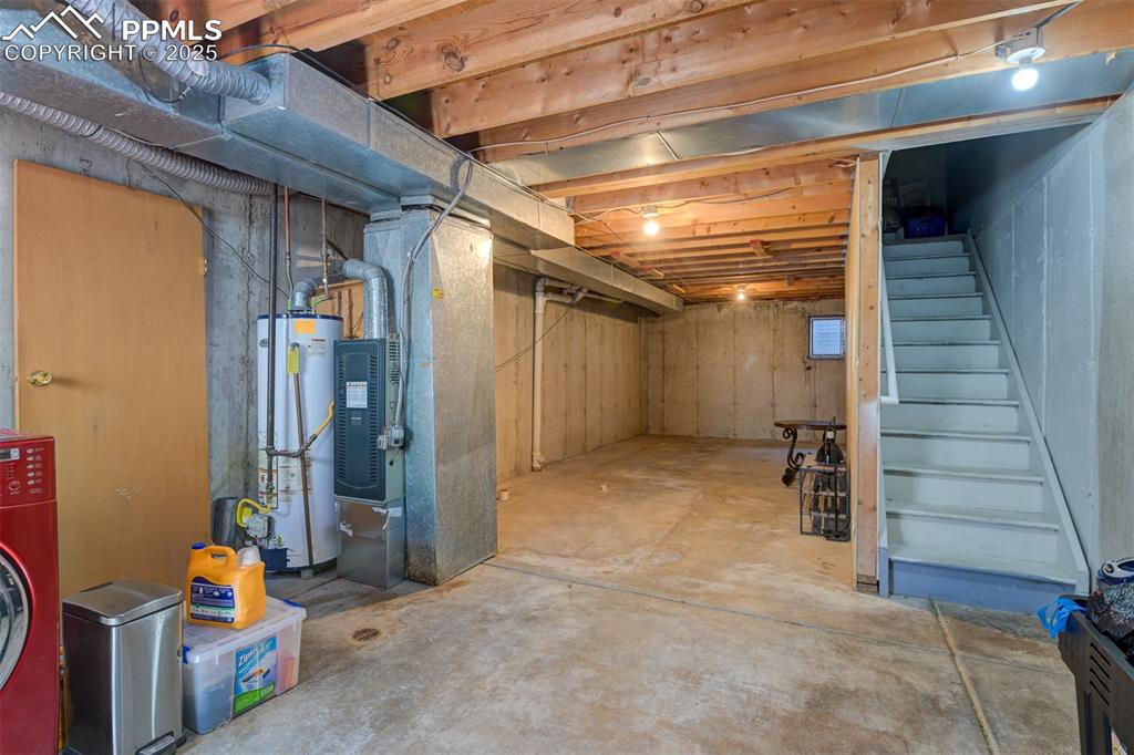 Image 28 of 34: Laundry area and unfinished basement. Perfect for storage or finish and add