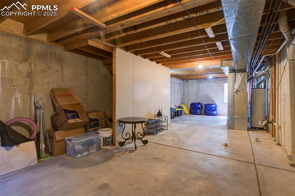 Image 29 of 34: Unfinished basement - pre-plumbed for a bathroom, additional bedroom or lea