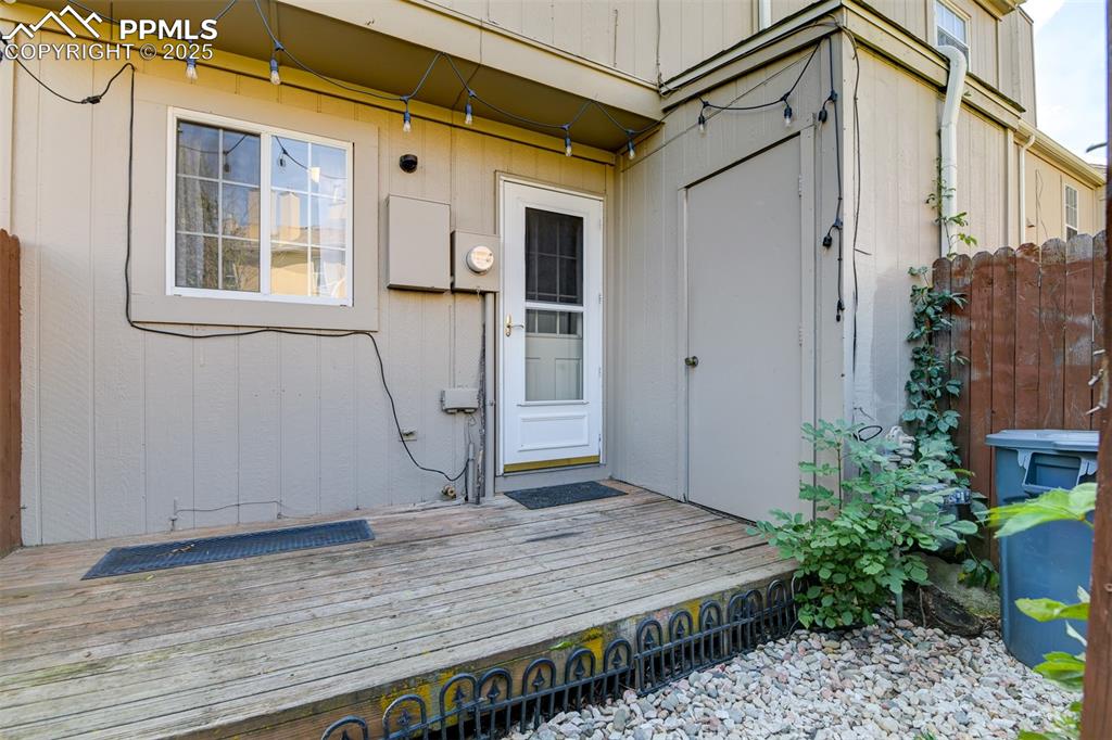 Image 31 of 34: Private fenced patio off the kitchen area. Additional storage area as well.